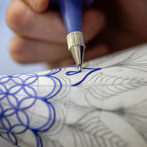 Rhian Malin decorating a mandala bottle in her workshop 2019